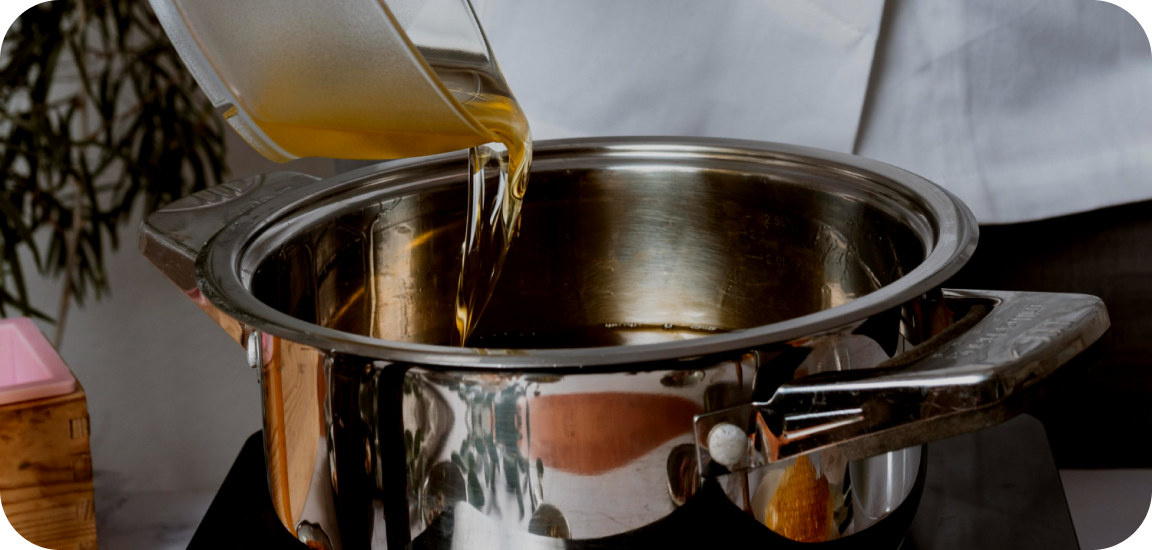 Used cooking oil being poured into a pot
